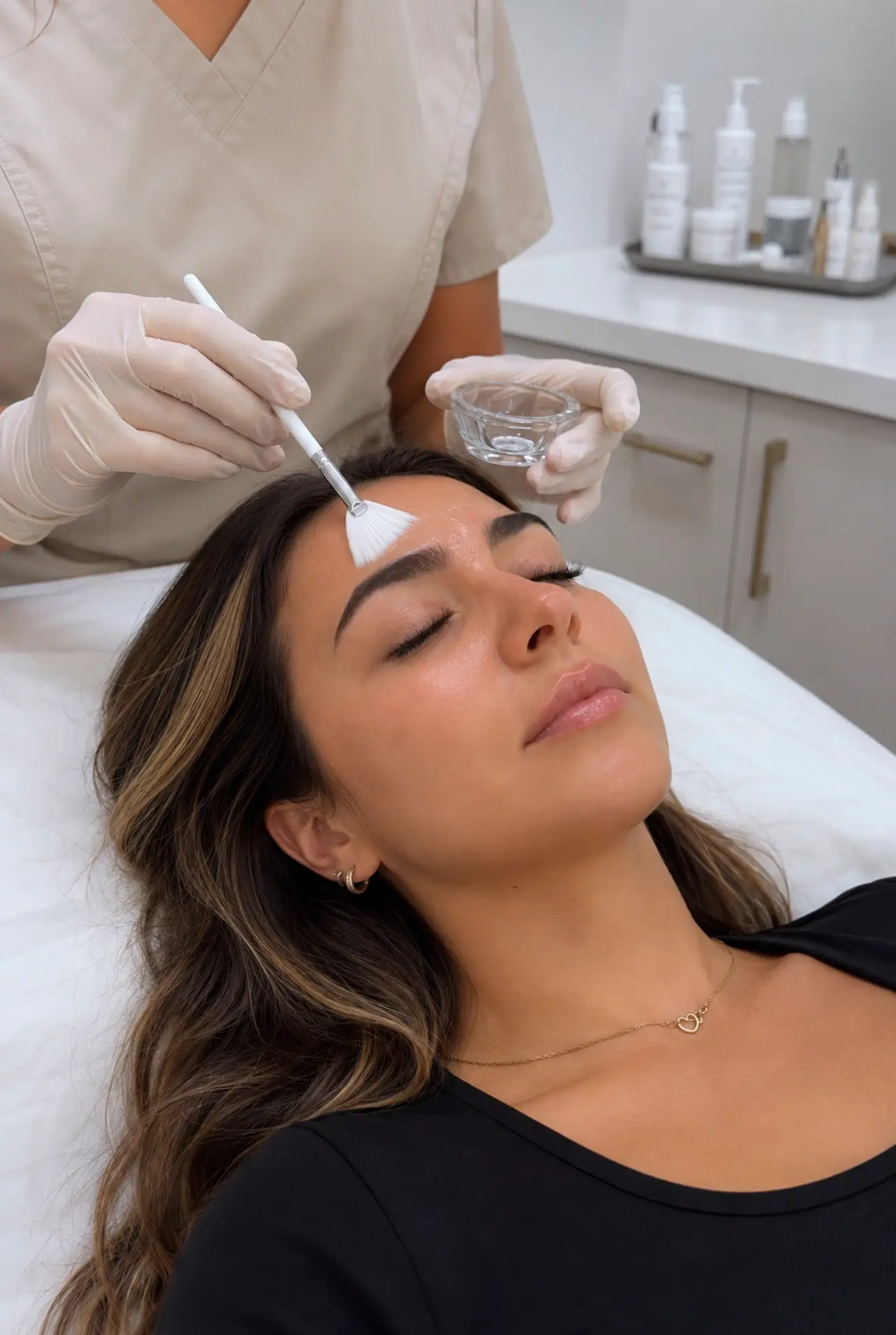 A dermatologist examining skin during a cosmetic consultation